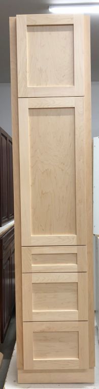 A wooden cabinet with three drawers is sitting on top of a white table.