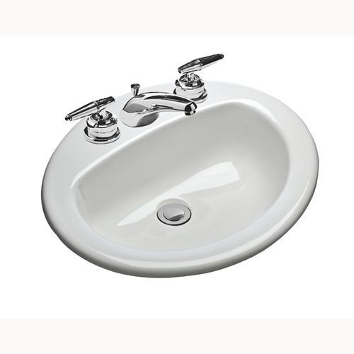 A white sink with chrome handles and a drain