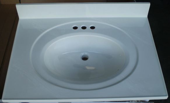A white bathroom sink with three holes in it