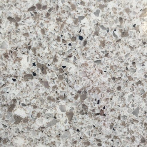 A close up of a white and brown granite counter top
