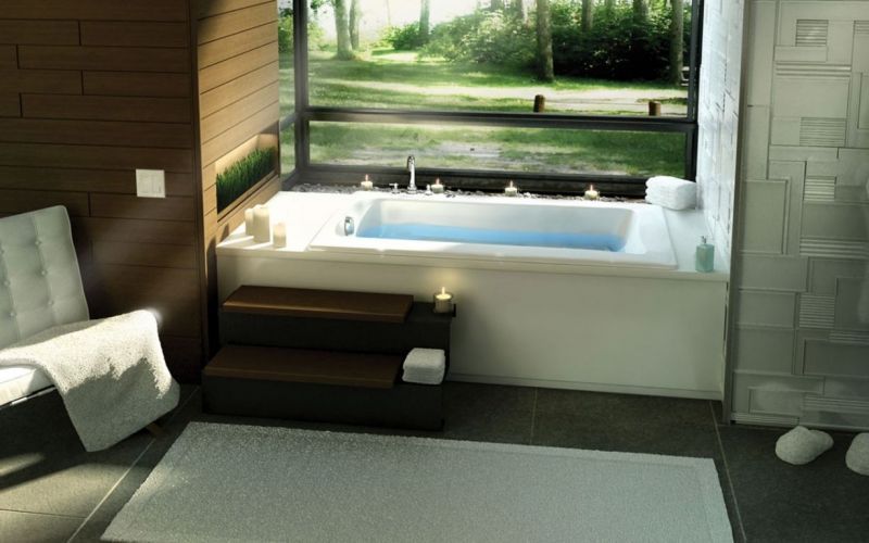 A bathroom with a bathtub and a chair in it