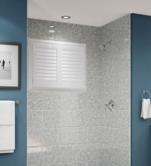 A bathroom with a shower and a picture on the wall