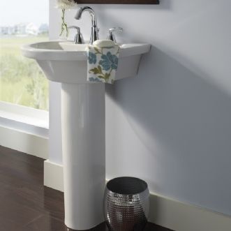 A bathroom with a pedestal sink and a window