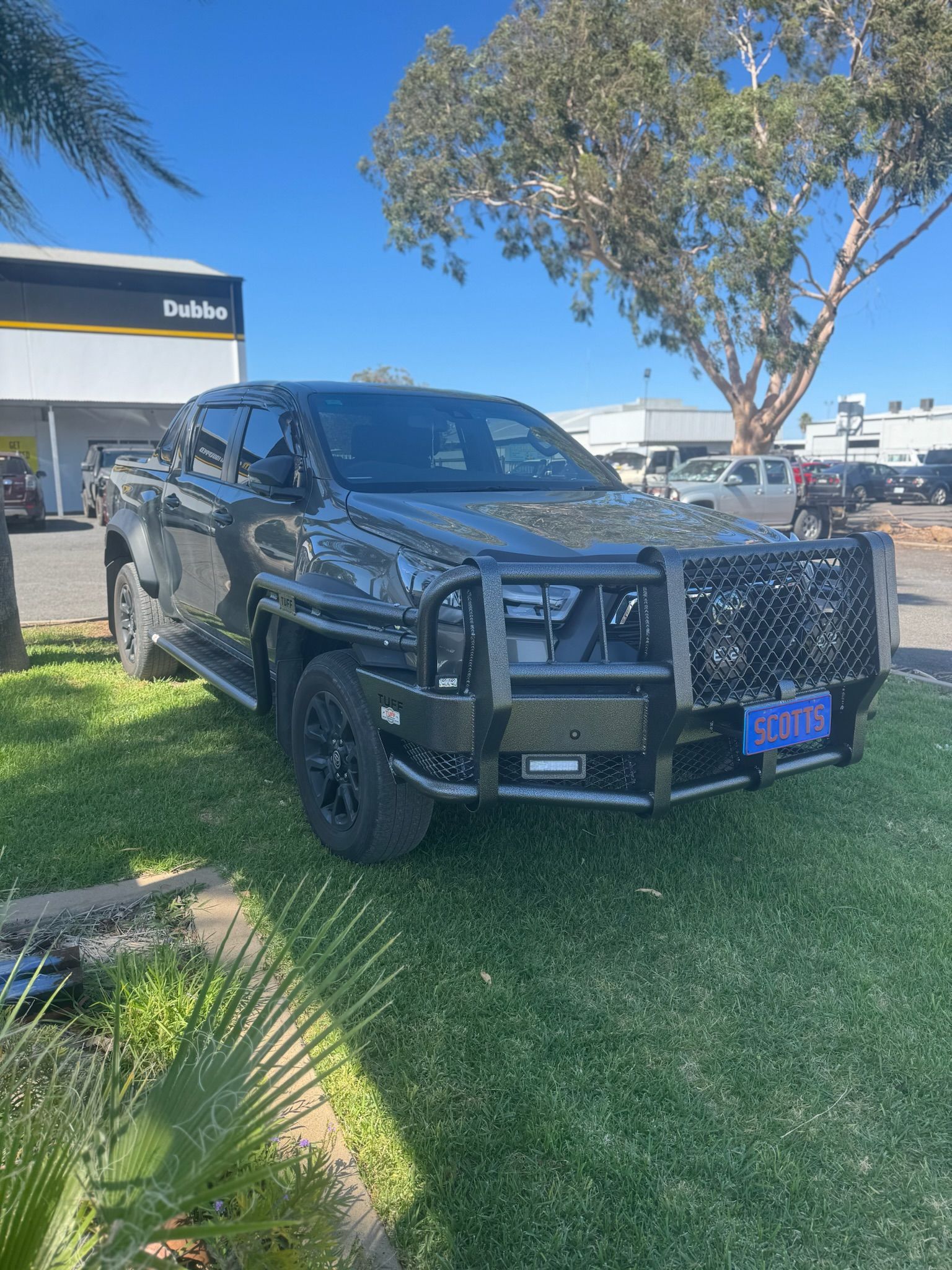 A man in a blue cap serving a woman at a counter — Scott's 4WD Parts Plus In Dubbo, NSW
