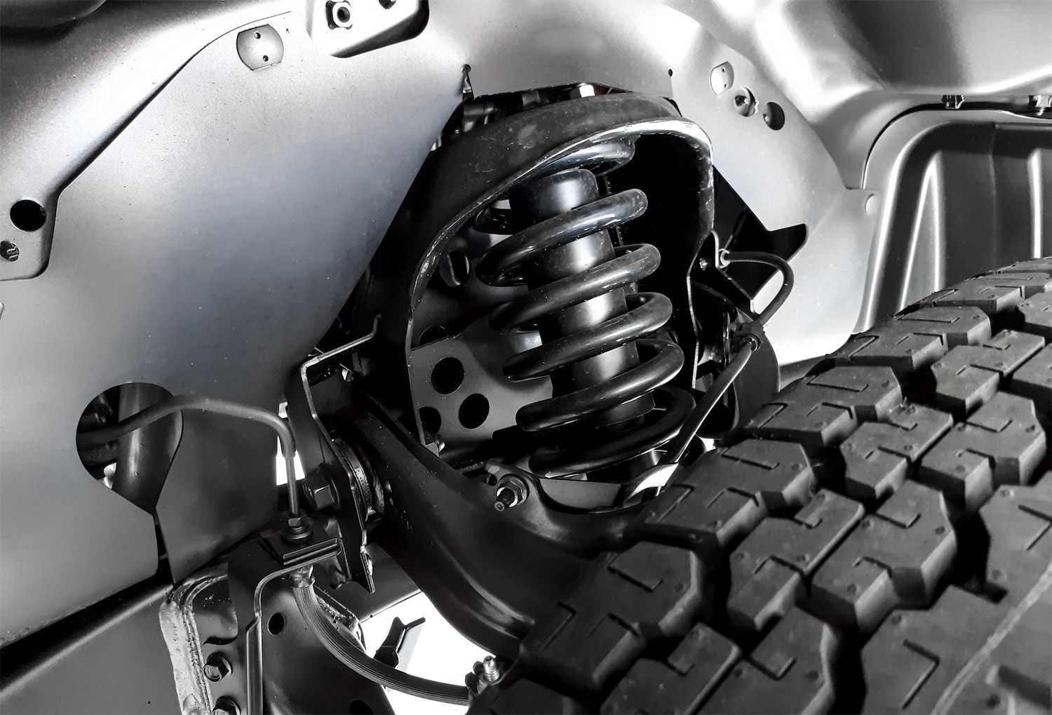 A Close-Up View Of A Vehicle's Front Suspension System