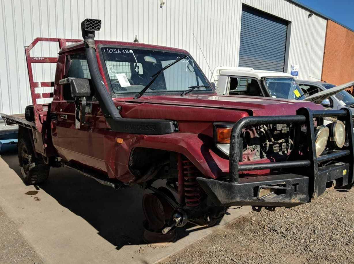 A Red Truck With A Snorkel On Top Of It Is Parked In Front Of A Building — Scott's 4WD Parts Plus In Orange, NSW