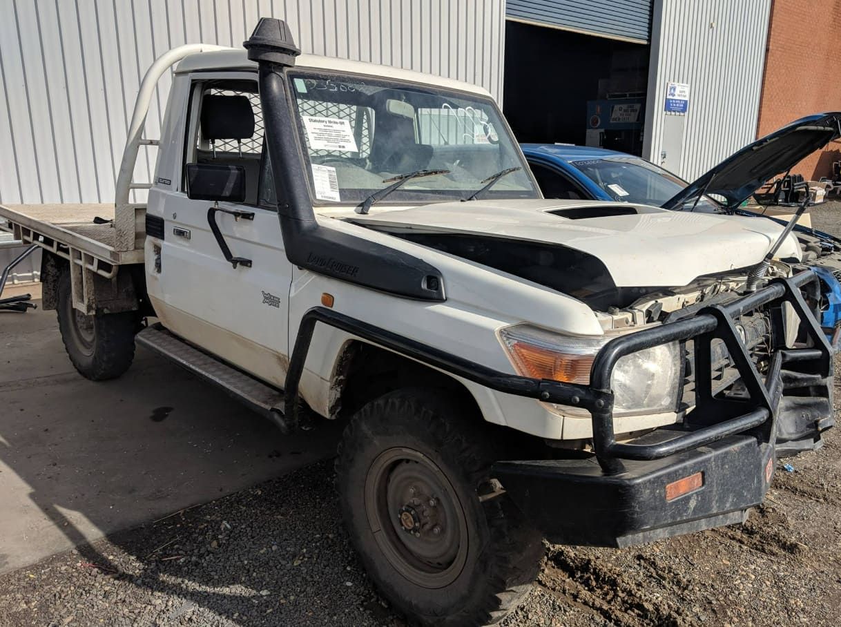 A White Truck With The Hood Up Is Parked In Front Of A Building — Scott's 4WD Parts Plus In Wagga Wagga, NSW