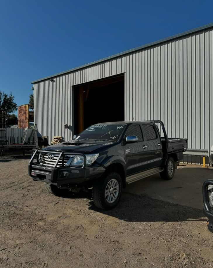 A Black Truck Is Parked In Front Of A Building — Scott's 4WD Parts Plus In Dubbo, NSW