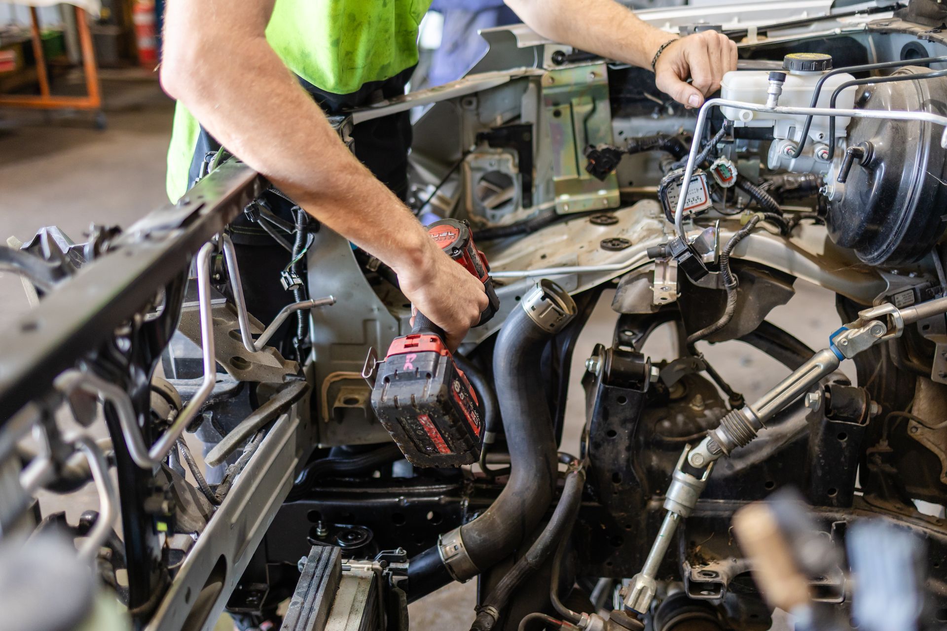 Mechanic Using A Drill On A Car Engine In A Garage