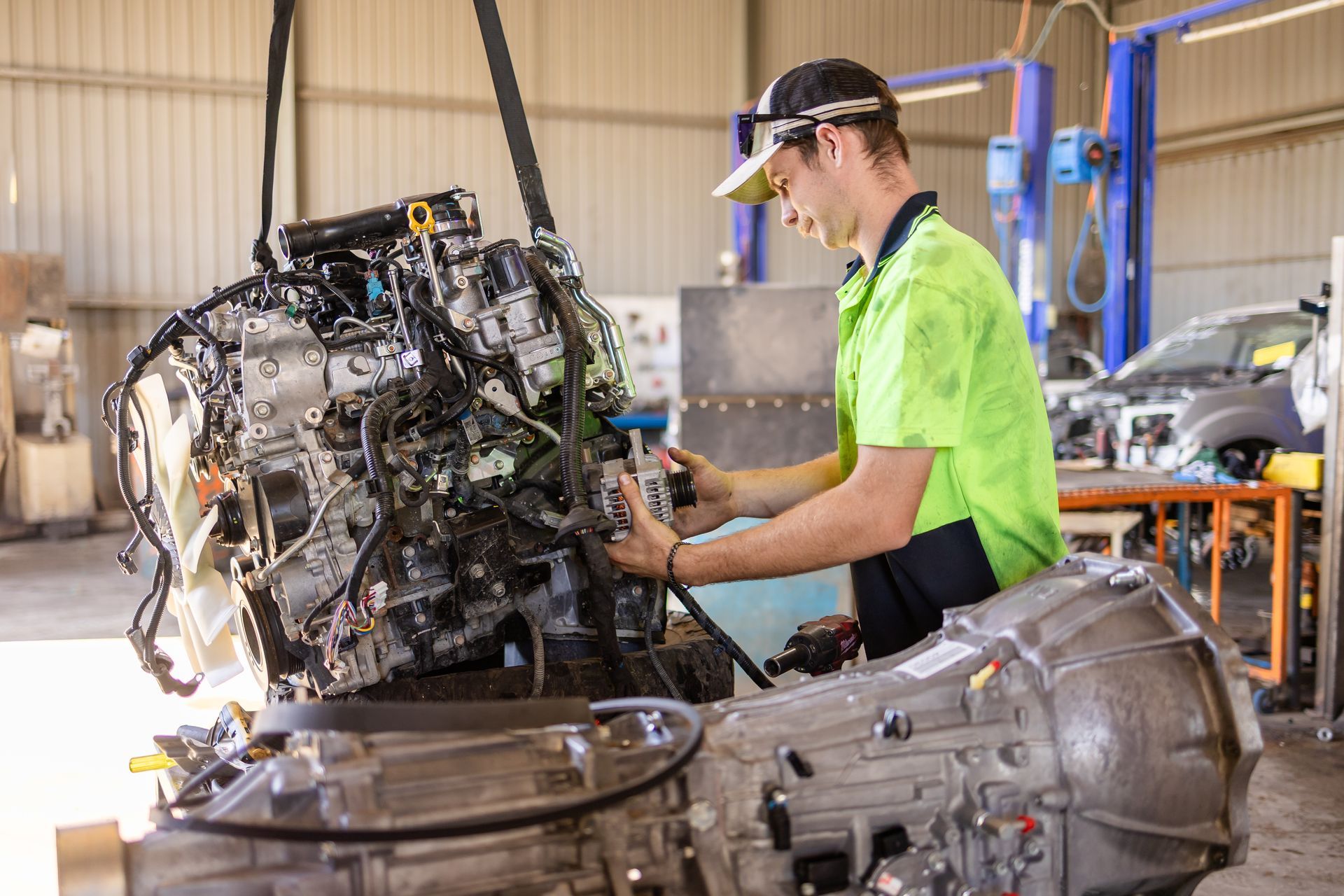 Mechanic working on a large engine — Scott's 4WD Parts Plus In Dubbo, NSW