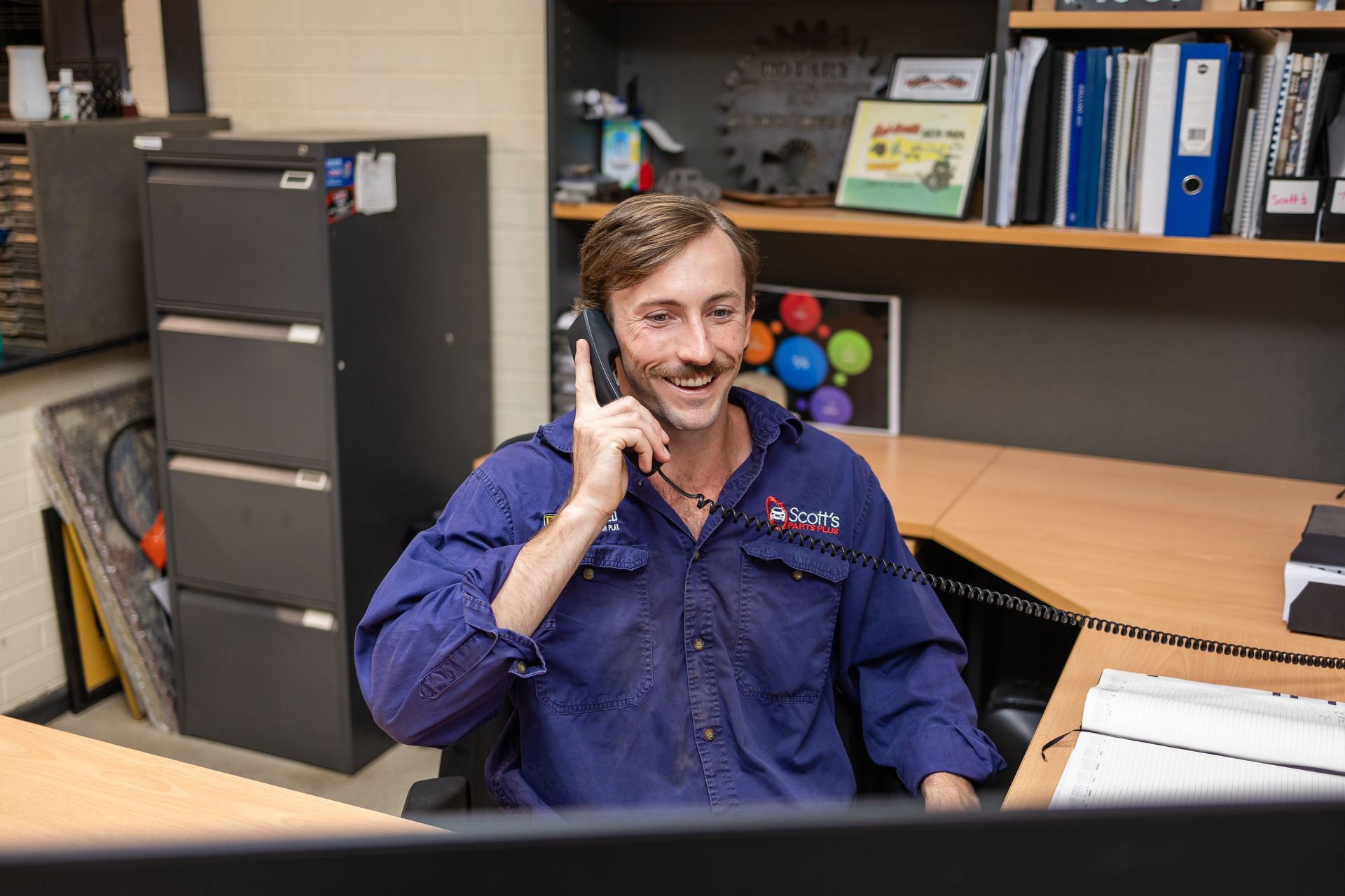 A man is working on a large engine — Scott's 4WD Parts Plus In Dubbo, NSW