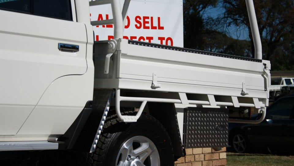 a white truck is parked next to a sign that says sell