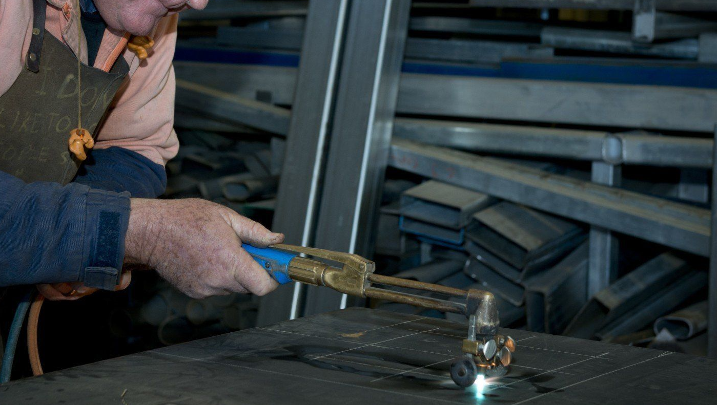 close up of man welding a piece of metal at rose valley steel works