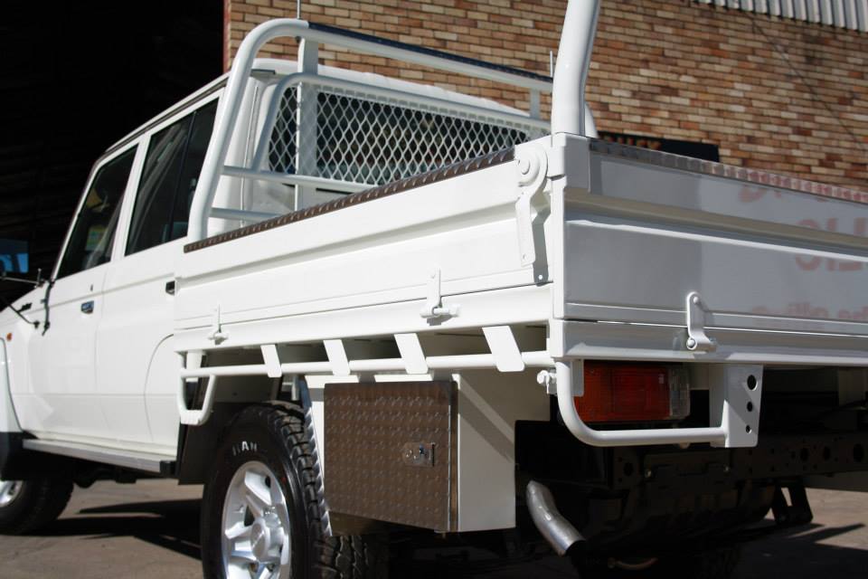 a white truck is parked in front of a brick building
