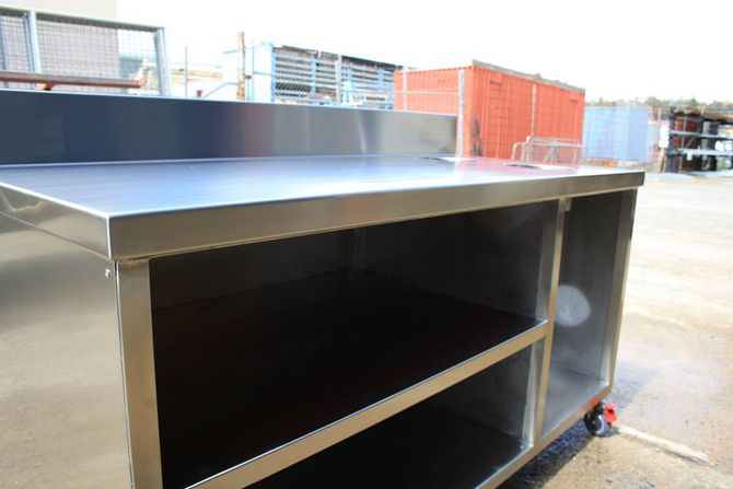 a stainless steel table with a shelf underneath it made by rose valley steel works