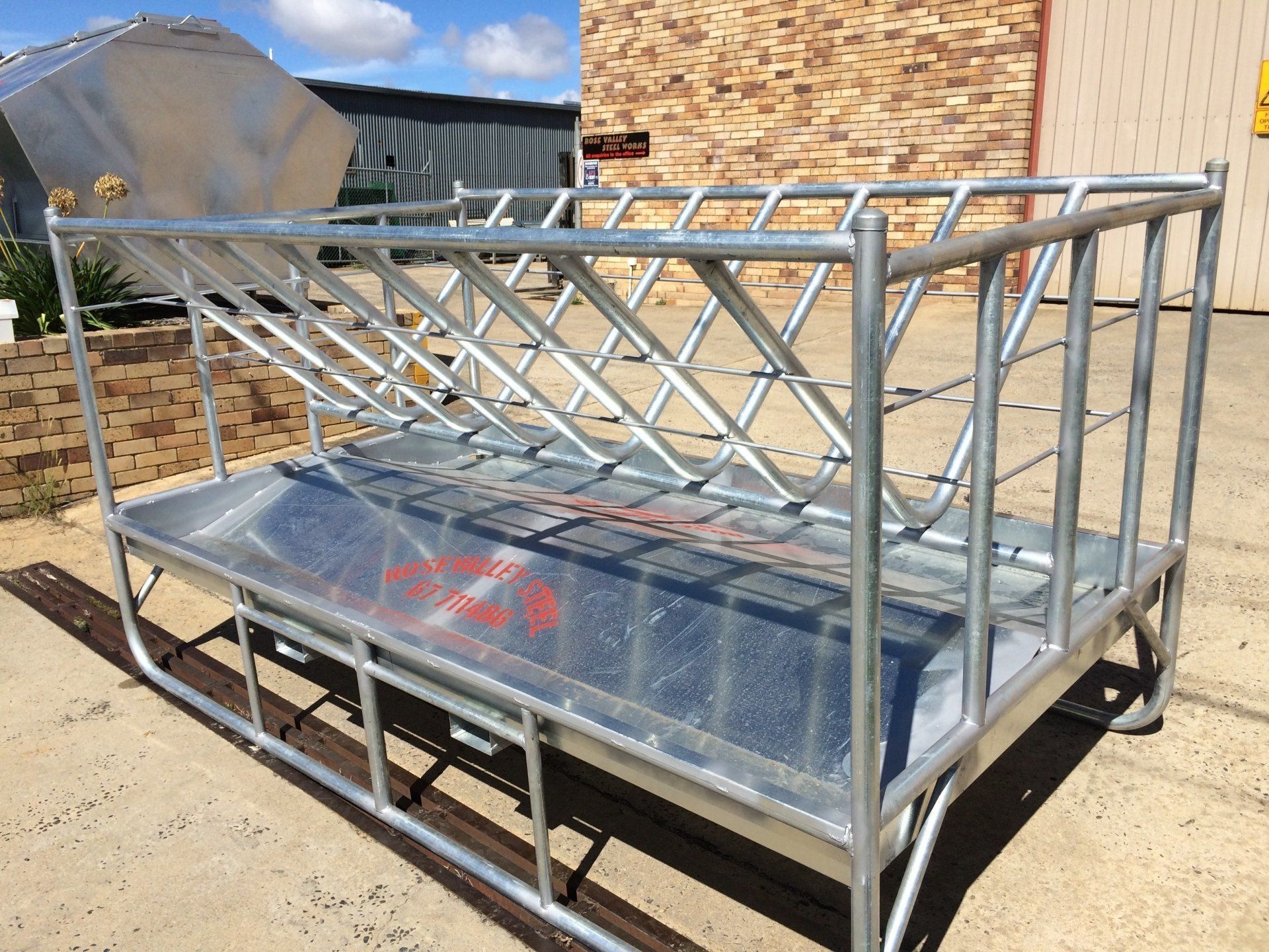 custom made steel feeder outside of brick building made by rose valley steel