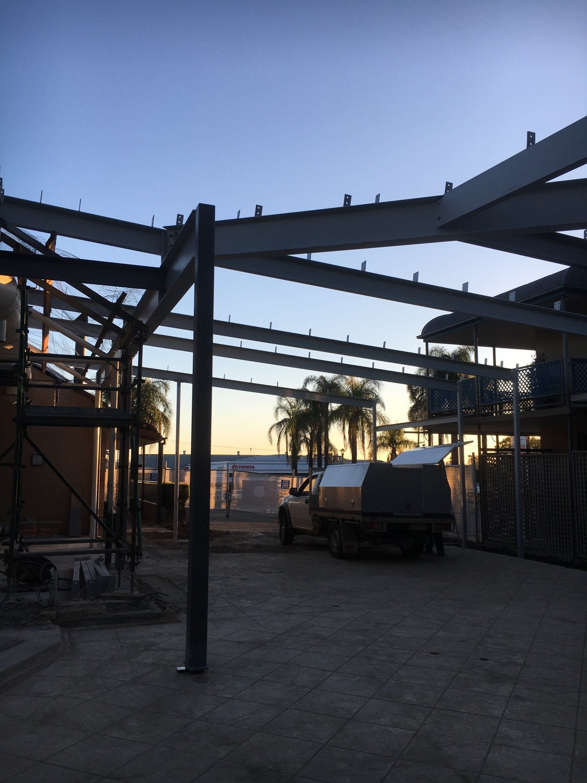 steel pergola frames at sunset