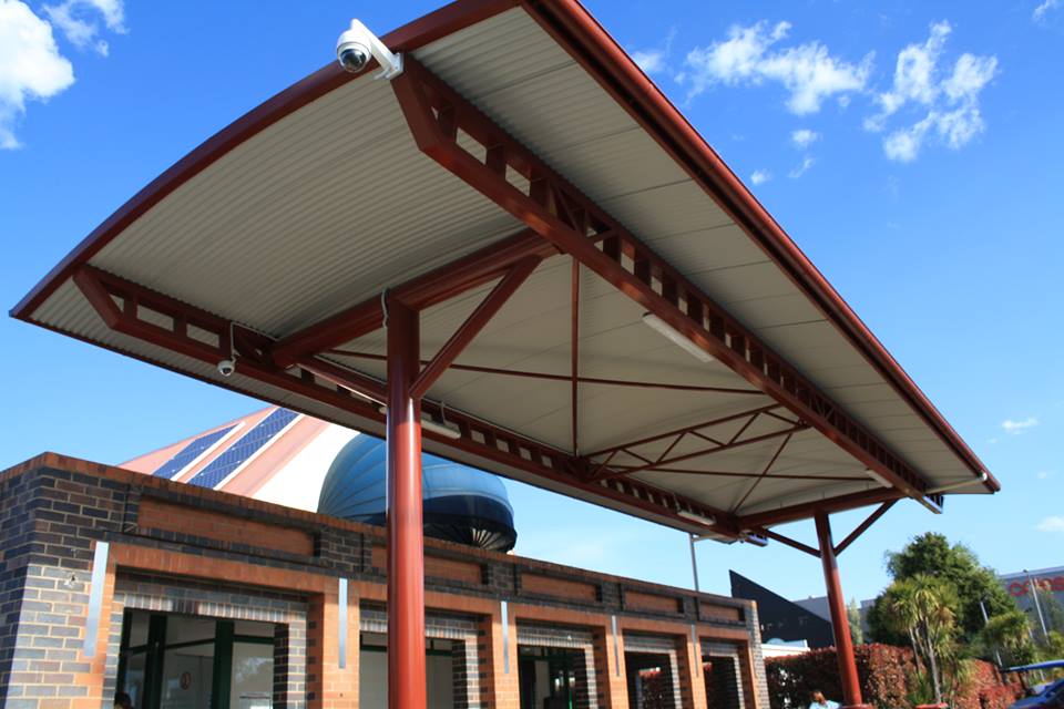 a brick building with a red and white awning over it