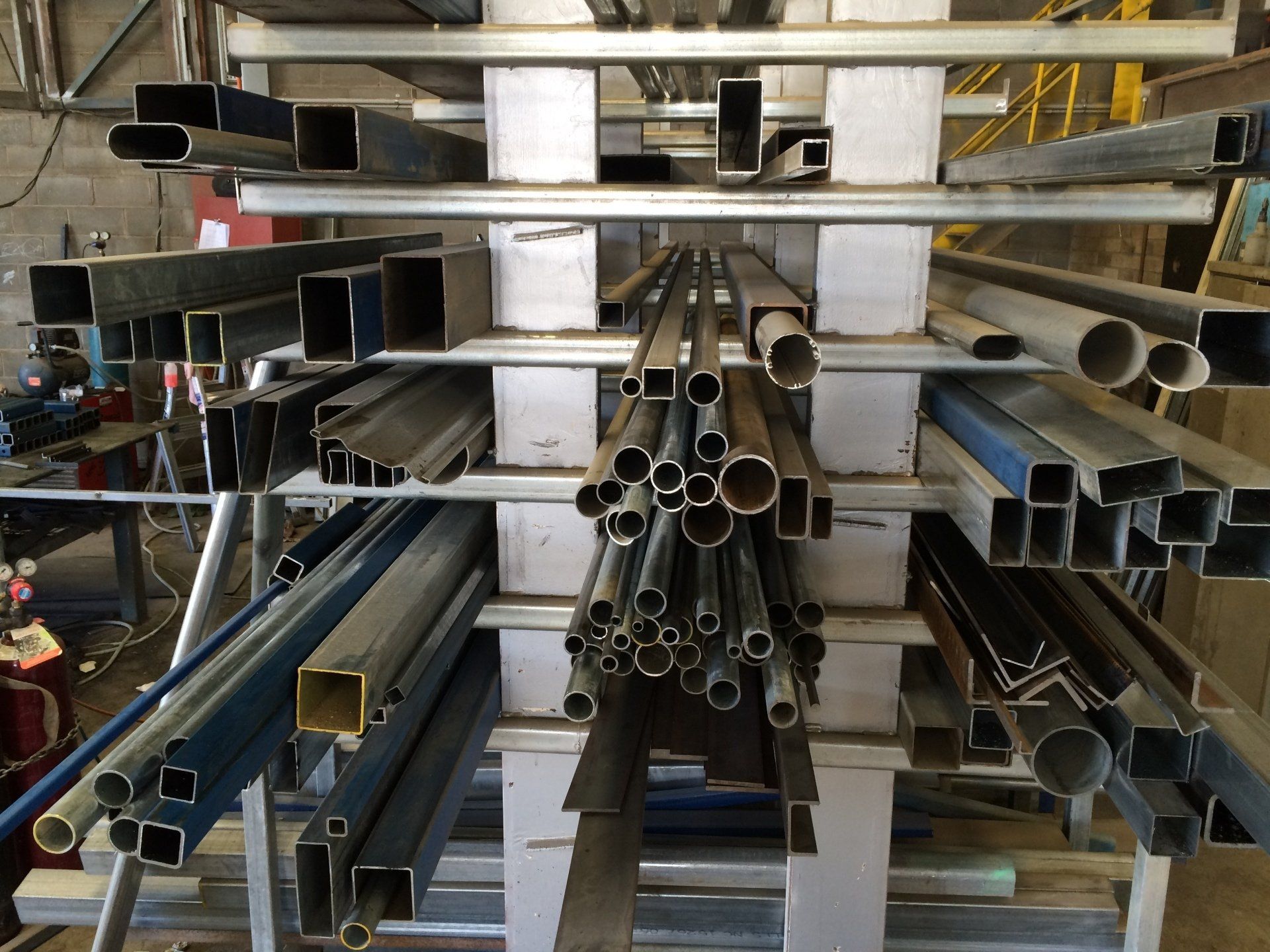 a bunch of metal pipes are stacked on top of each other