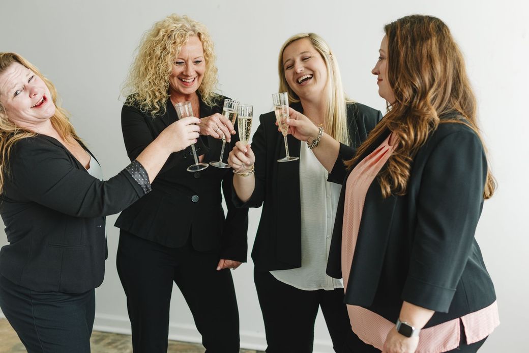 A group of women are toasting with champagne glasses.