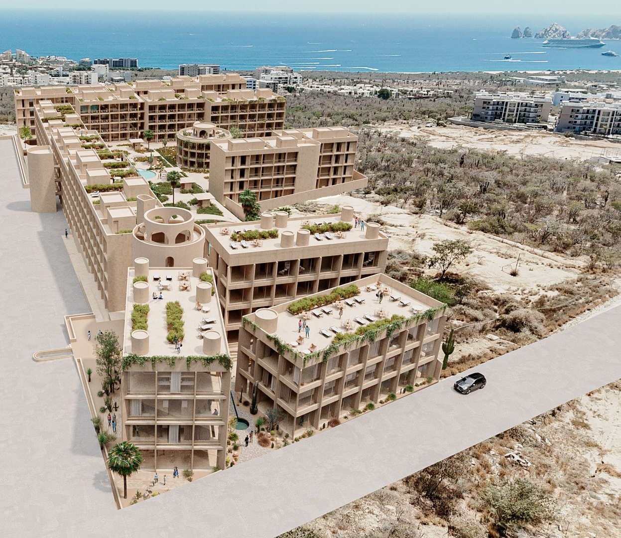 Aerial view of a multi-story resort complex with rooftop gardens, near the ocean. Beige buildings, blue water.