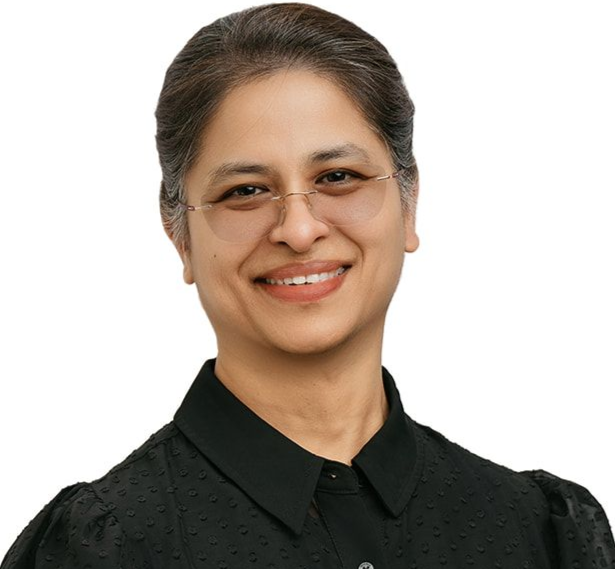 A smiling person with glasses, wearing a black collared shirt, posing against a white background.