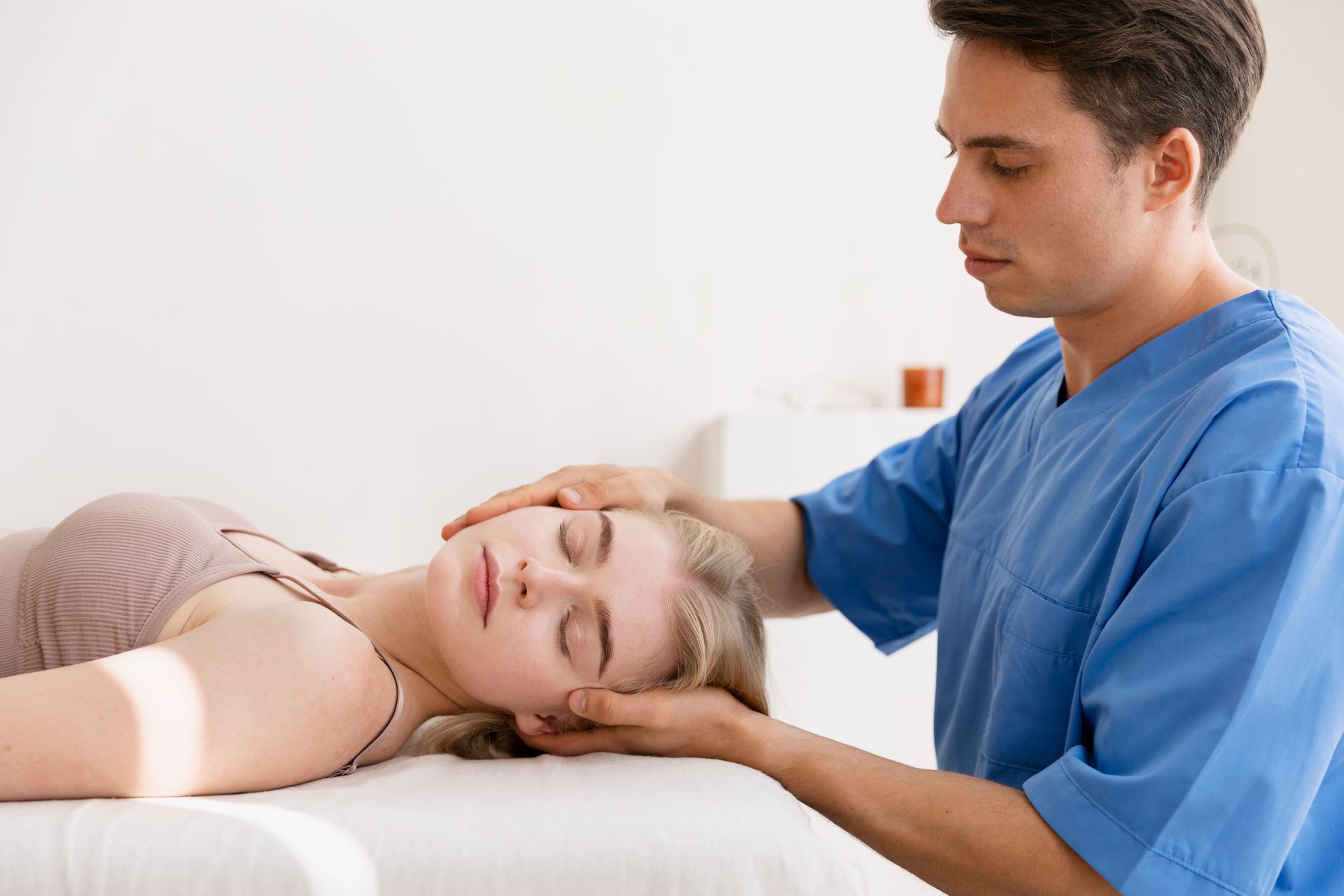 A man is giving a woman a head massage.