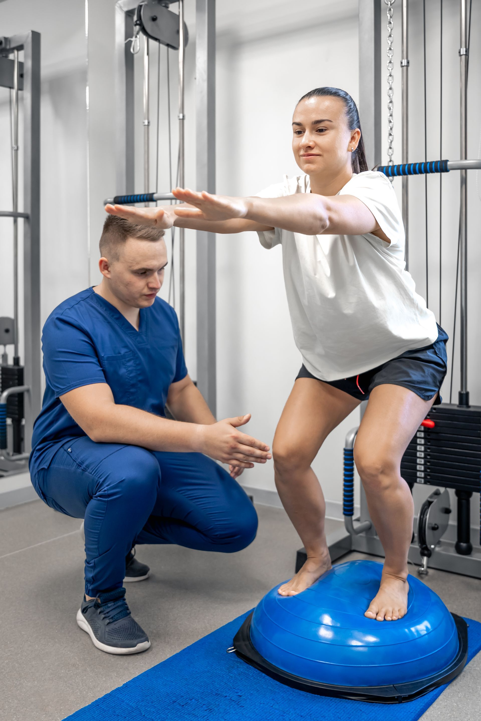 A woman is holding her back in pain.