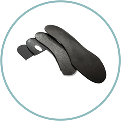 A pair of black insoles in a circle on a white background