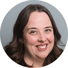 A woman with long brown hair is smiling in a circle.