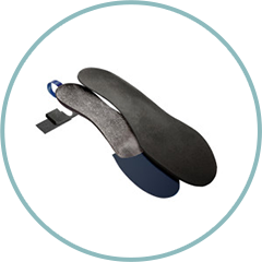 A pair of black insoles in a circle on a white background