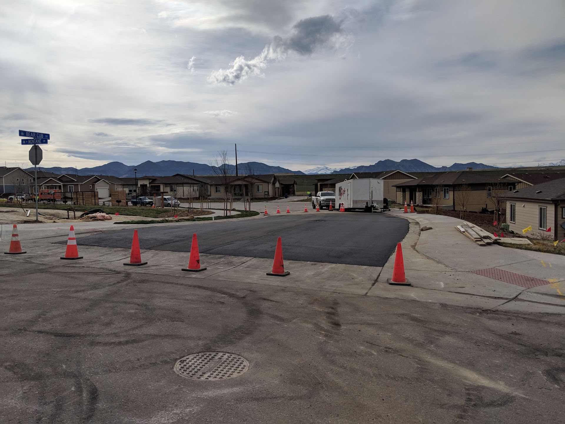 A lot of traffic cones are on the side of the road.