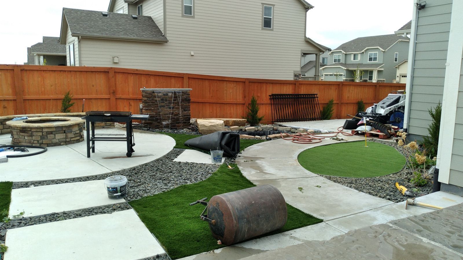 A lawn is being installed in the backyard of a house.