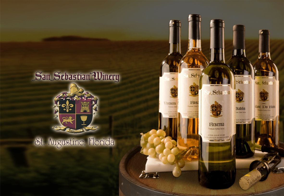 A bunch of bottles of wine on a barrel with the word san sebastian on the bottom