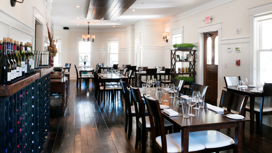 A large dining room with tables and chairs and a bar