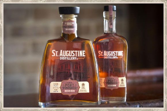 Two bottles of st. augustine whiskey are sitting on a table
