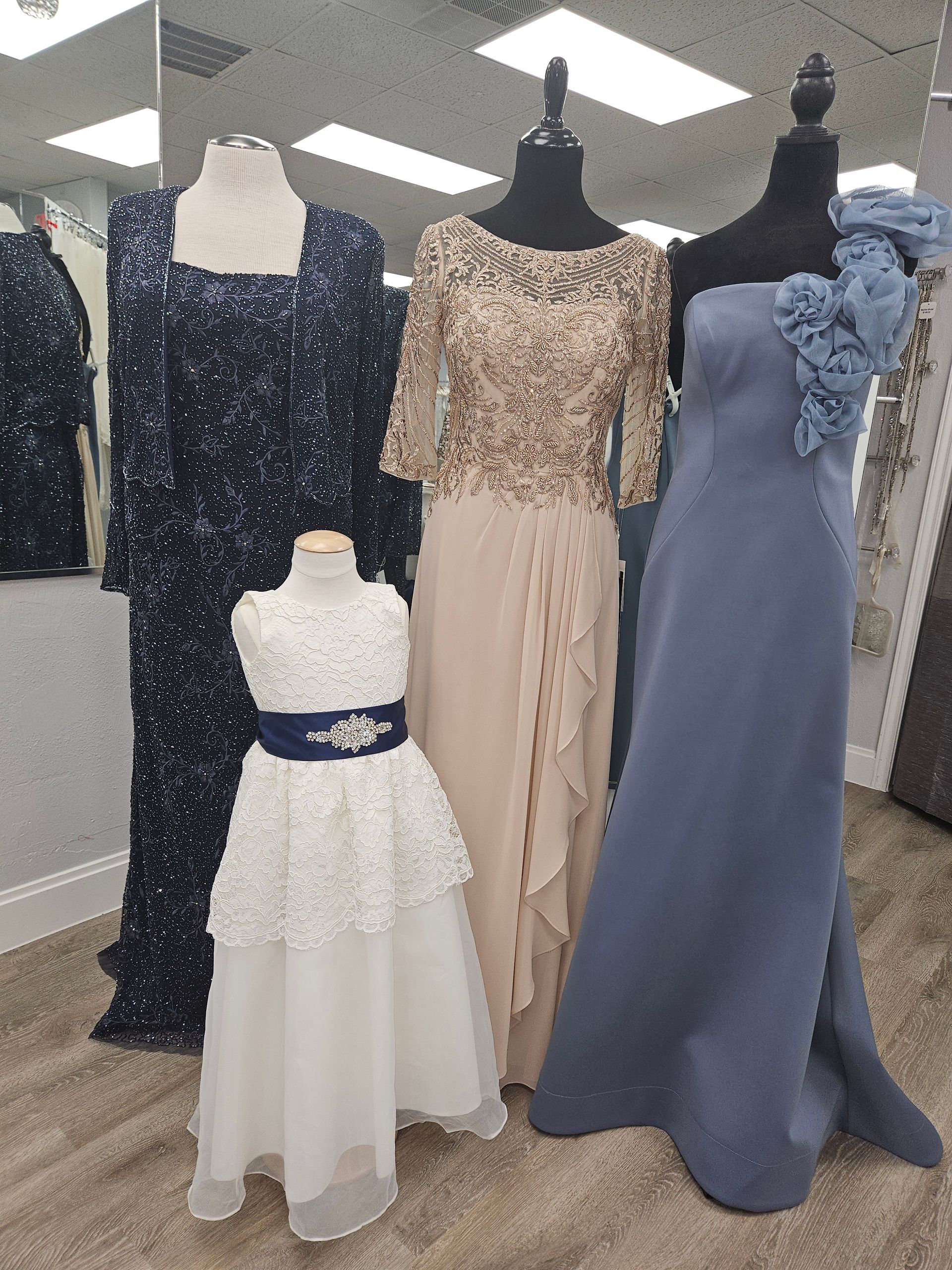 A bride and her mother are holding hands and kissing in a room.