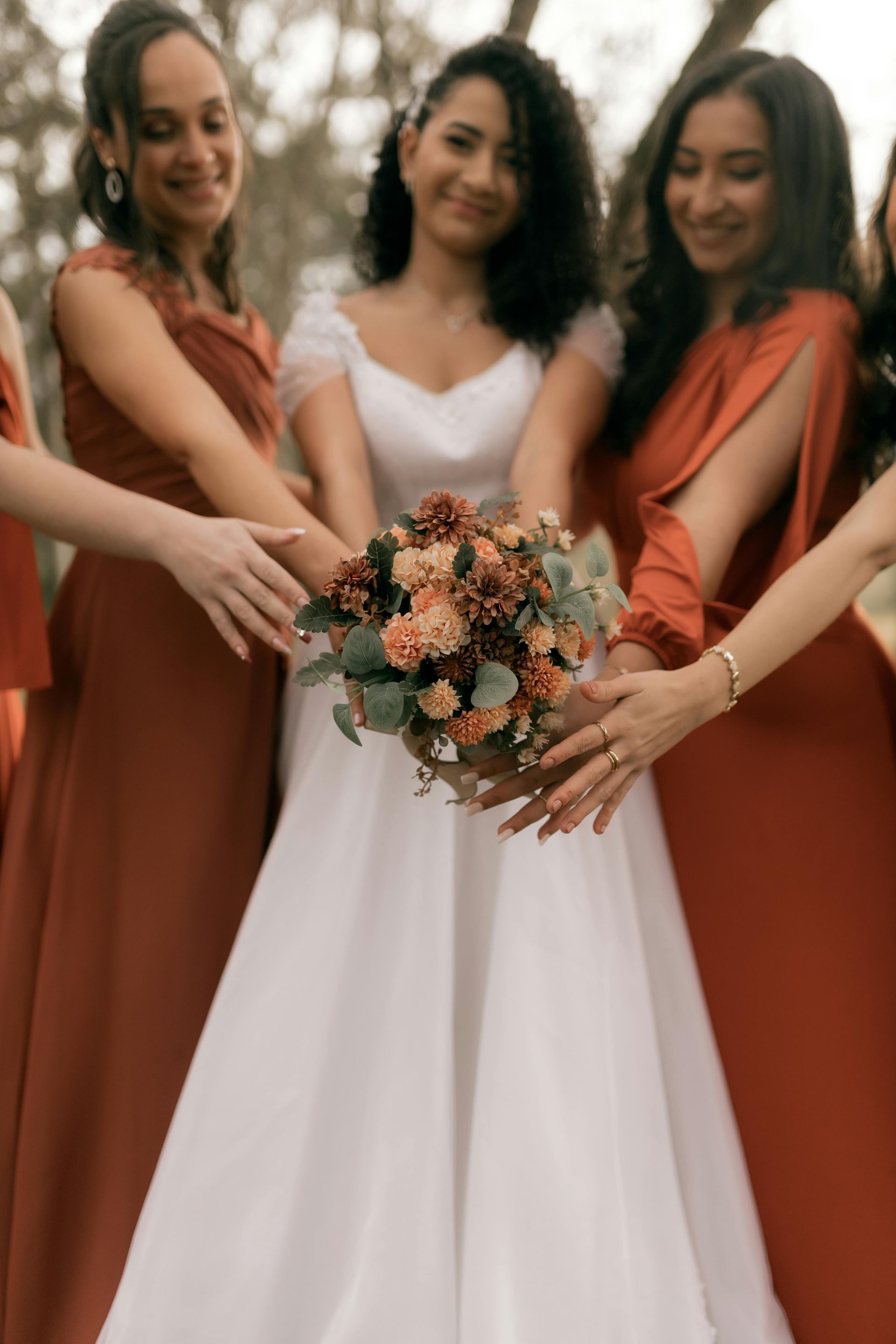 A row of wedding dresses hanging on a rack in a store.