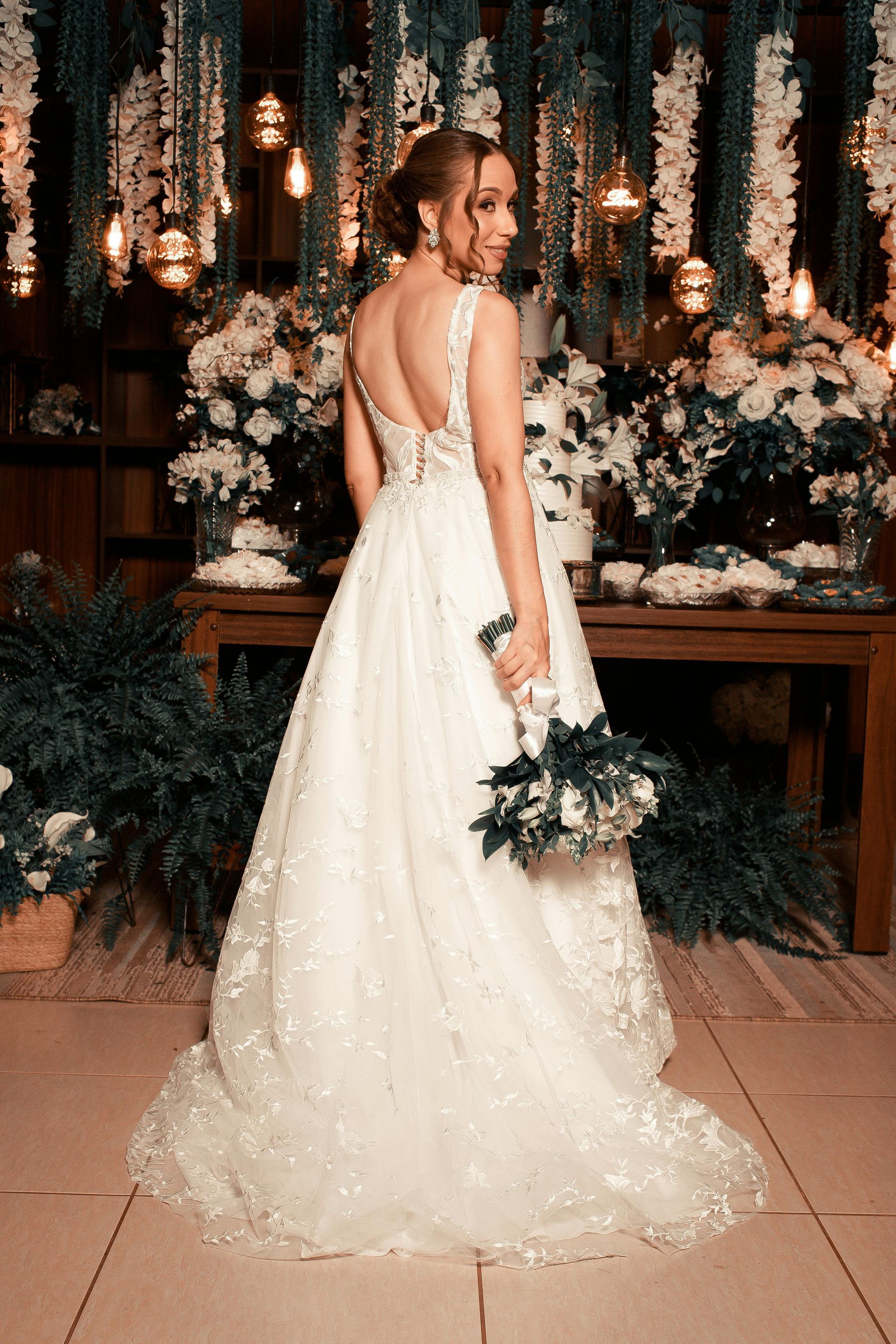 Two wedding dresses are displayed on mannequins in a bridal shop.