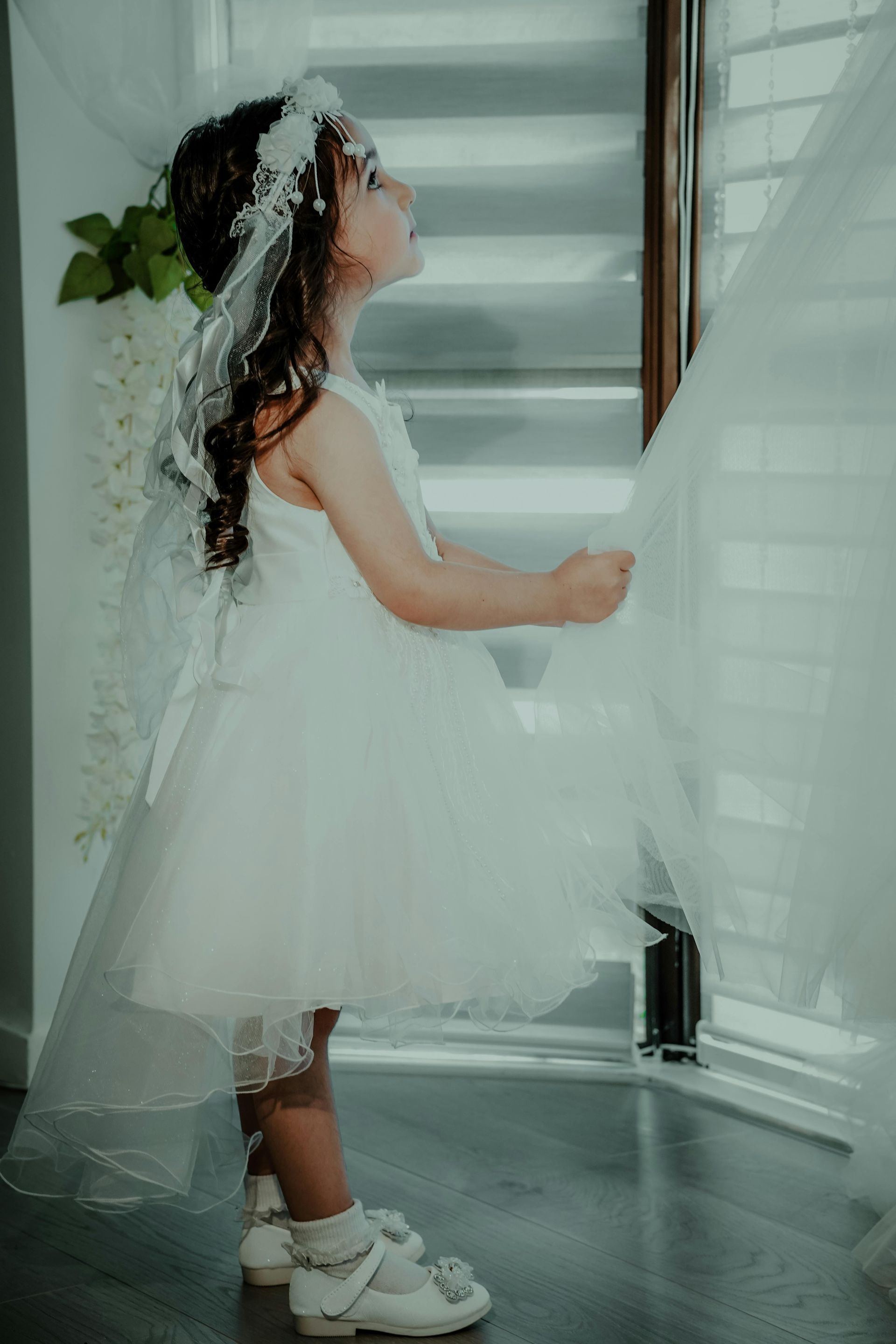 A bunch of white dresses are hanging on a rack