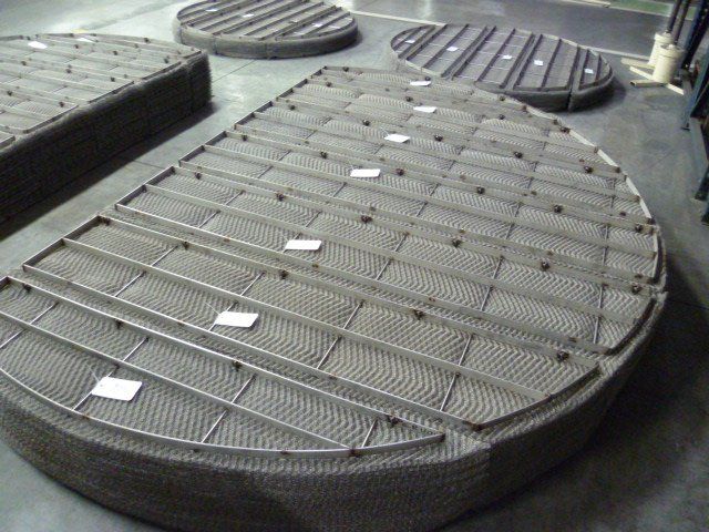 Woven metal mesh filters with synthetic overlay