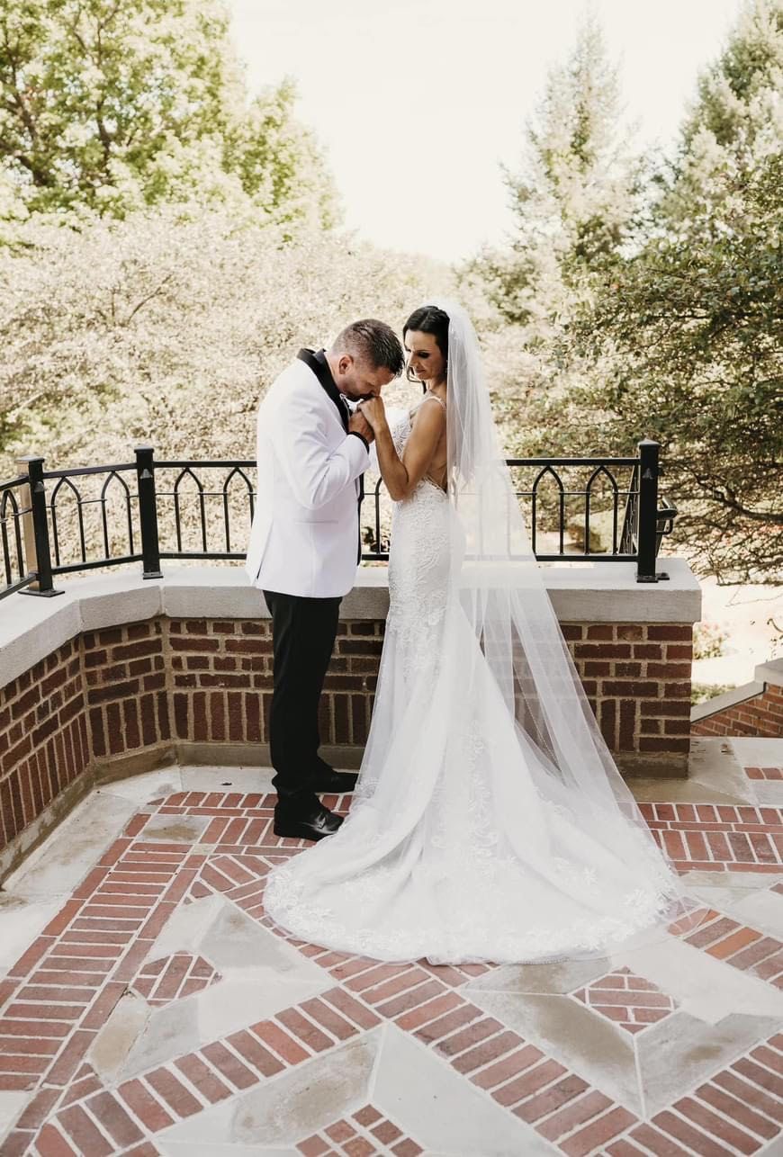 Groom kissing brides hand