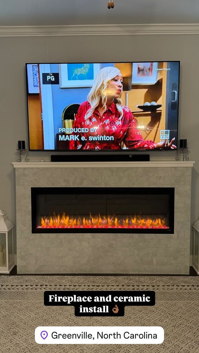 TV above a fireplace; woman on screen, fireplace flames. In Greenville, NC.