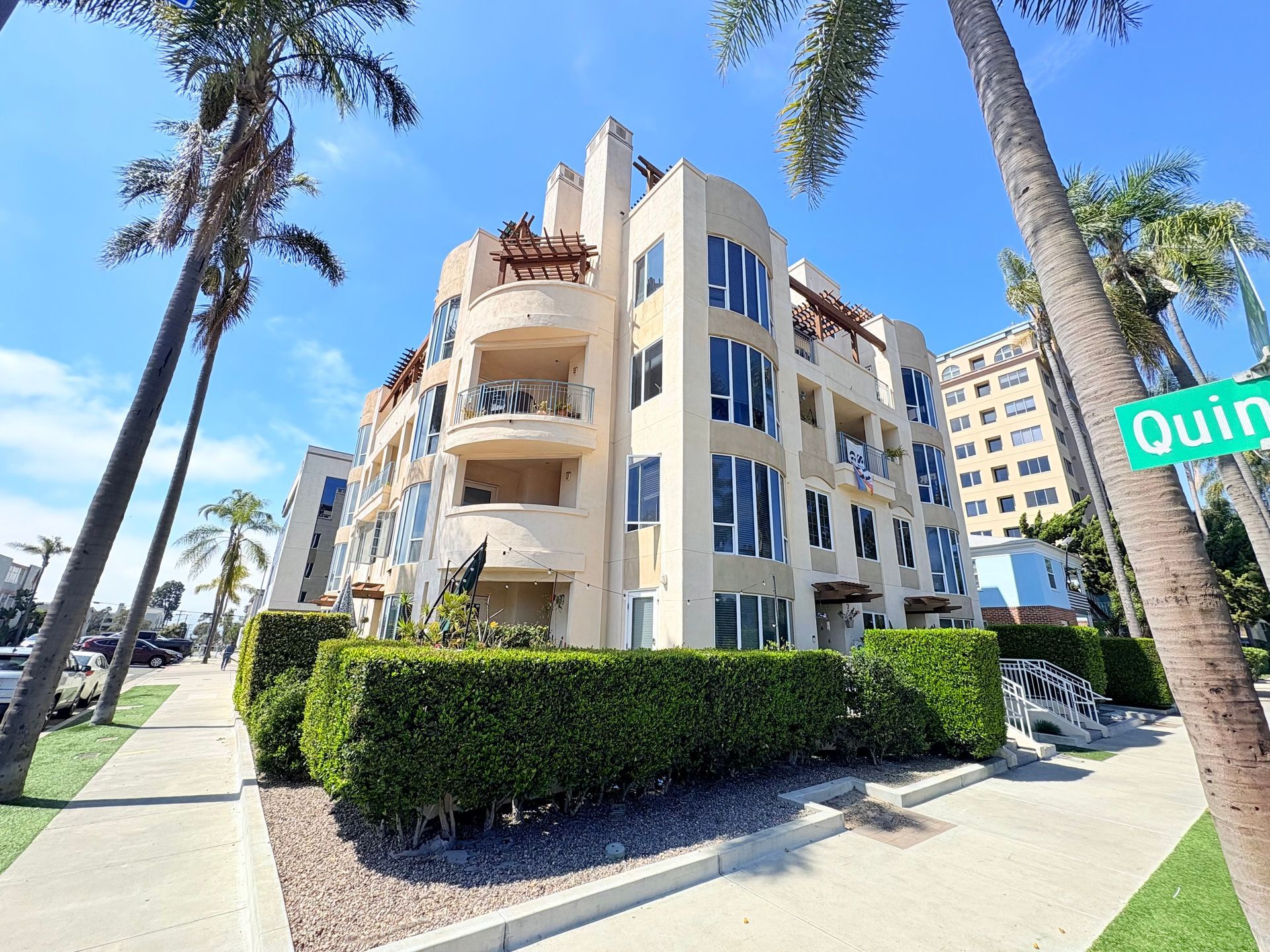 A large building with a green sign that says quinn