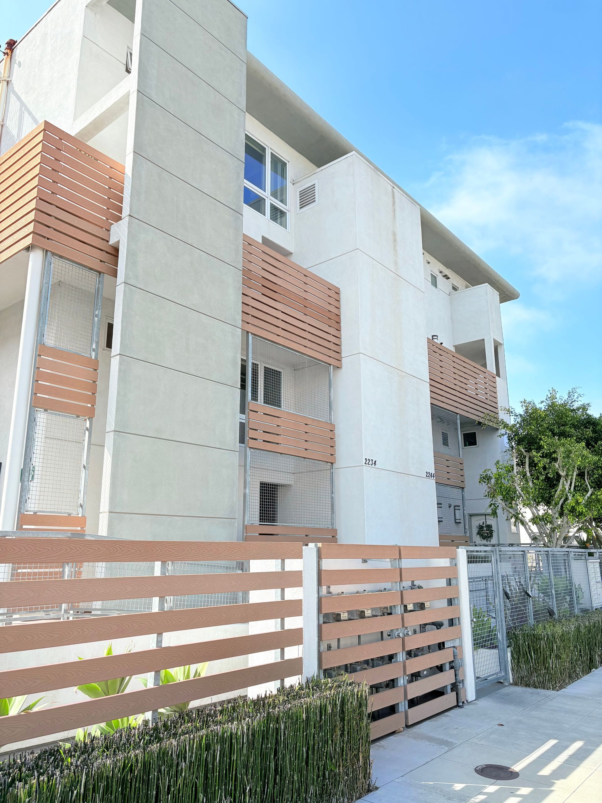 A large white building with a wooden fence around it