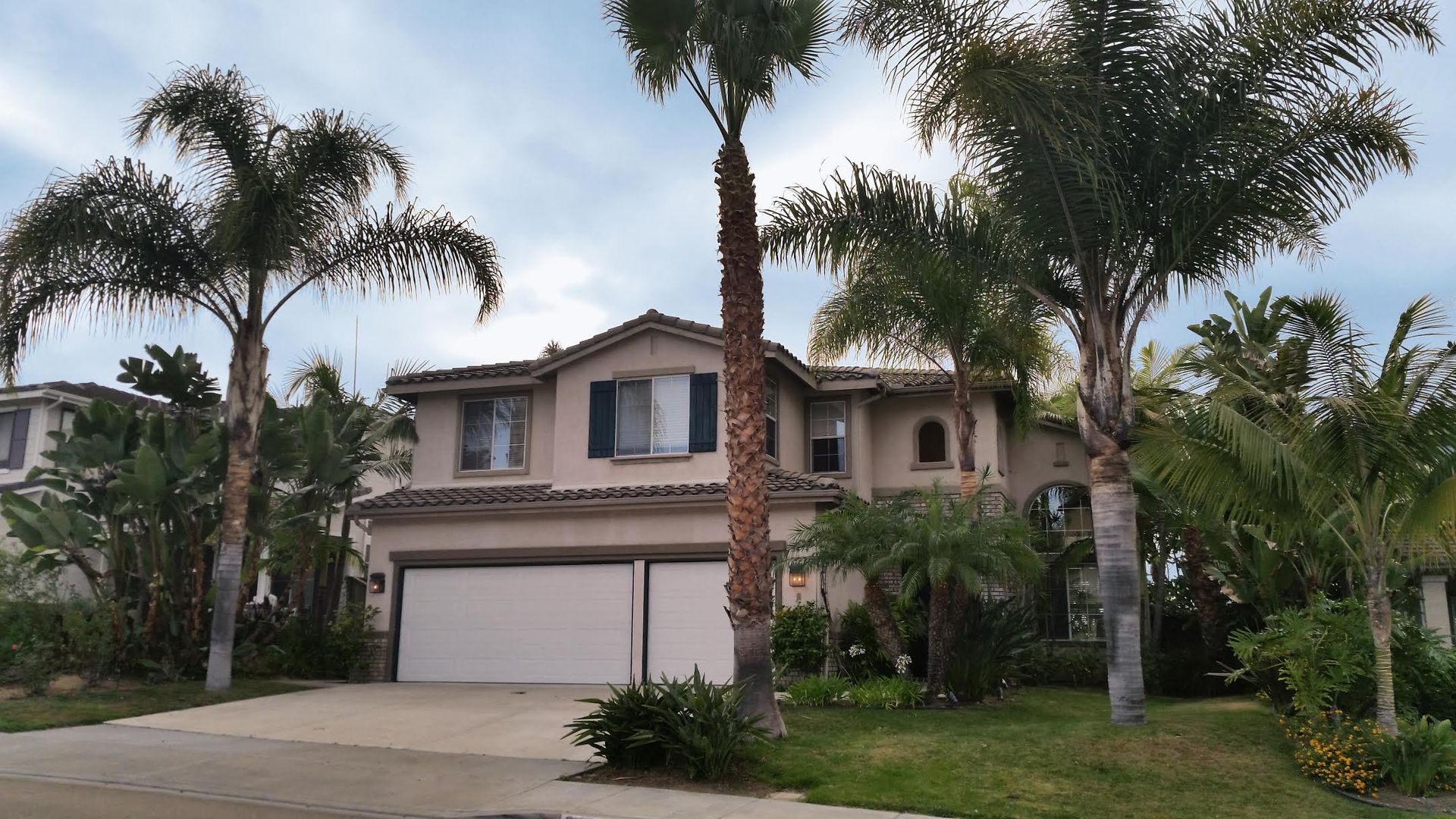 A large house with palm trees in front of it