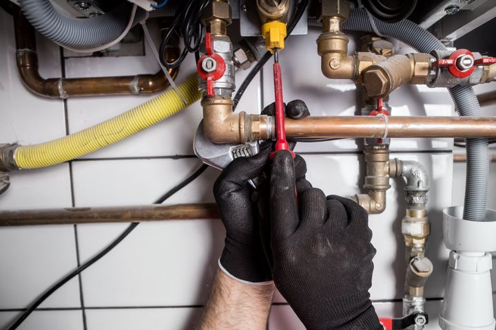 Technician Servicing Boiler — Campbell’s Complete Plumbing in Tamworth, NSW