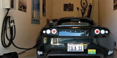 EV Charging station installed in home garage. Tesla personal charging station