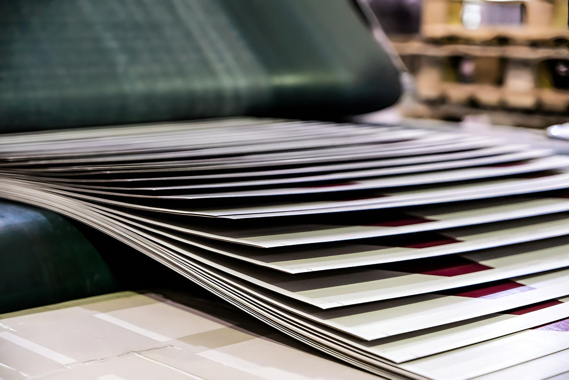 Printed Sheets of Paper Being Fed Out of a Printing Press, Fanning Out on a Conveyor Belt — C & D Manufacturing In Caboolture, QLD