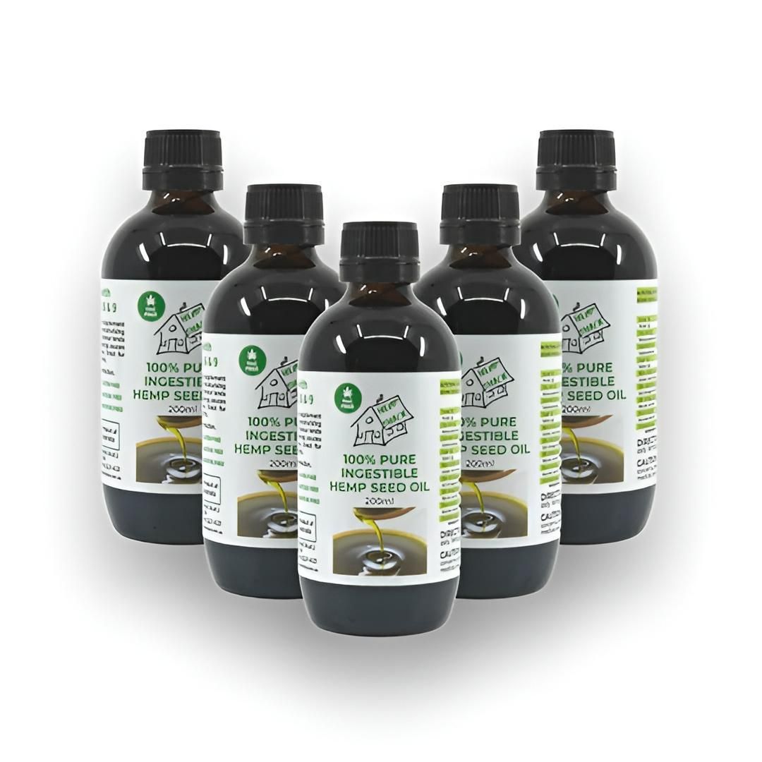 Five Bottles of Dark Liquid With Black Caps, Likely Essential Oils, Arranged Together Against a White Background. Each Bottle Has a Label With Green Accents — C & D Manufacturing In Caboolture, QLD